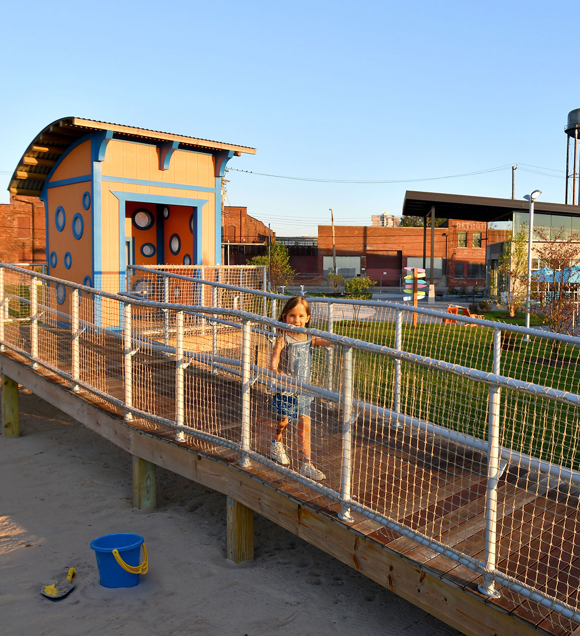 kids play house with ramp at valade park with sand below