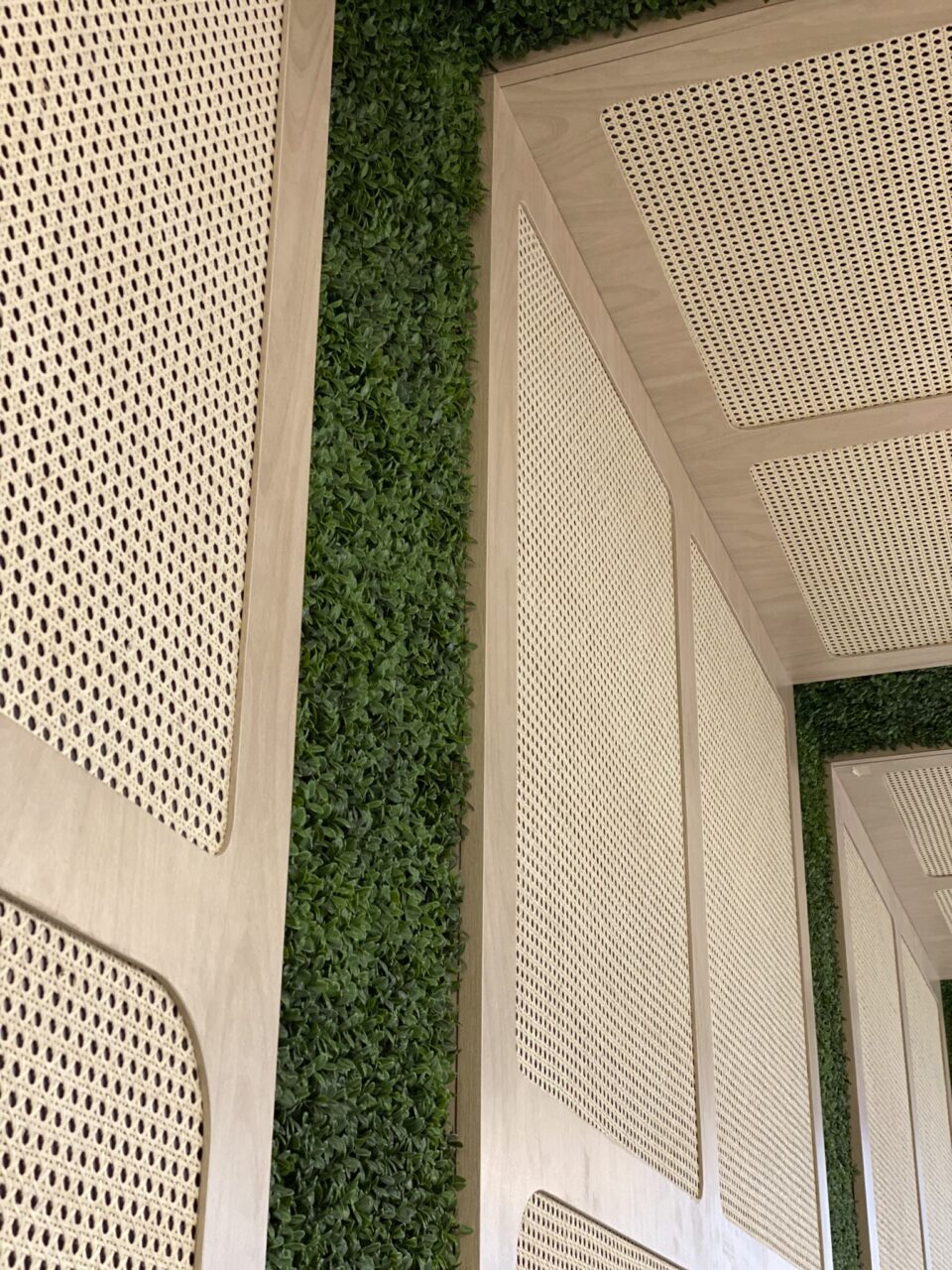 light wood, rattan, and moss wall covering