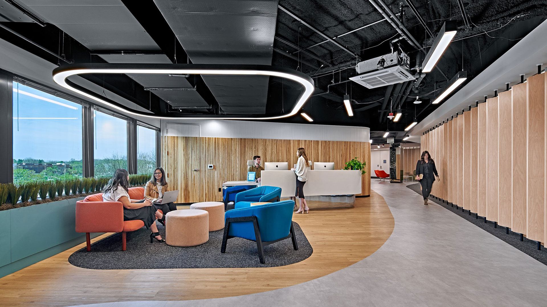 evolution gaming lobby with millwork details on the walls and floor, and bold furniture in front of the reception desk