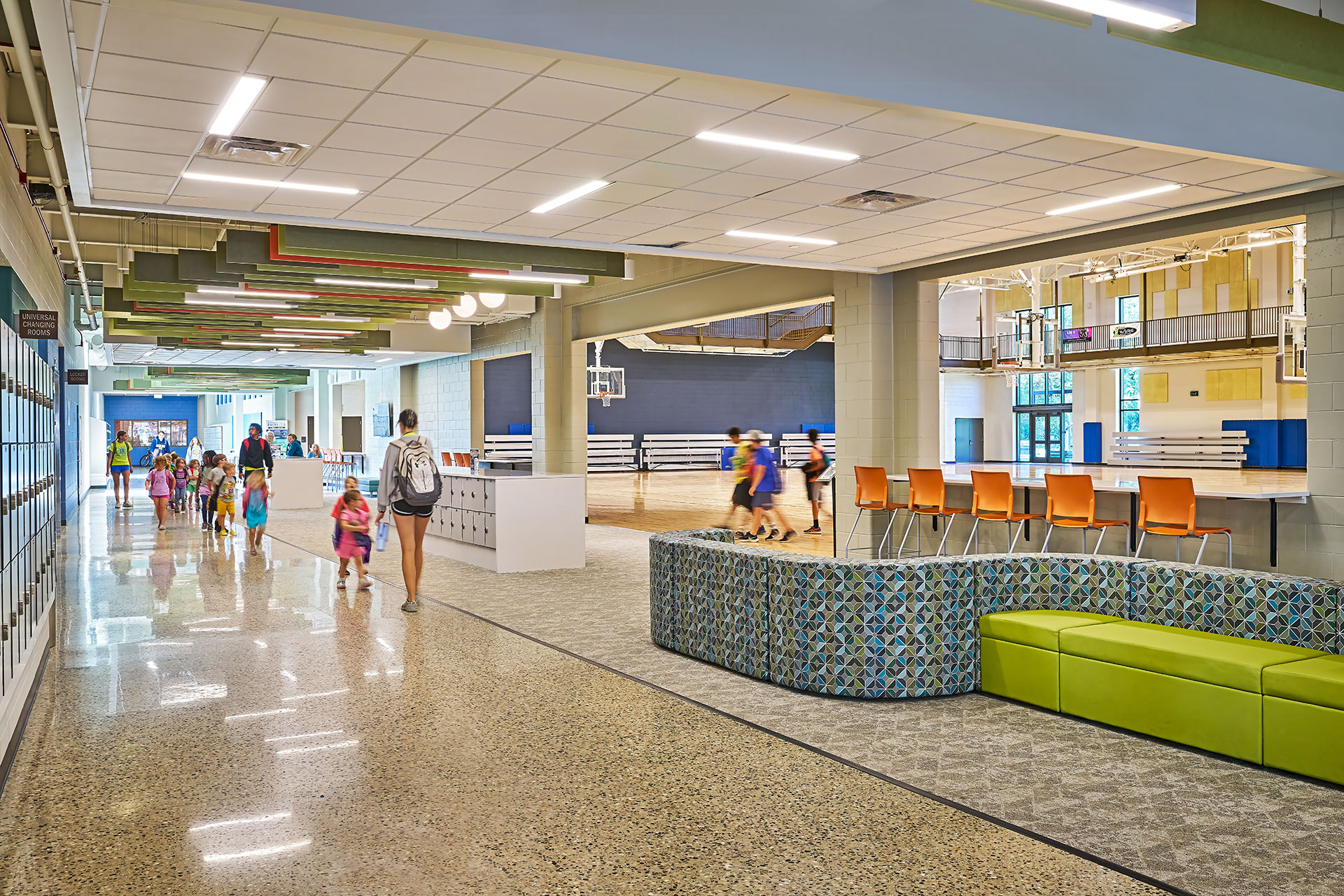 main concourse with soft seating, lockers, and connection to the basketball court