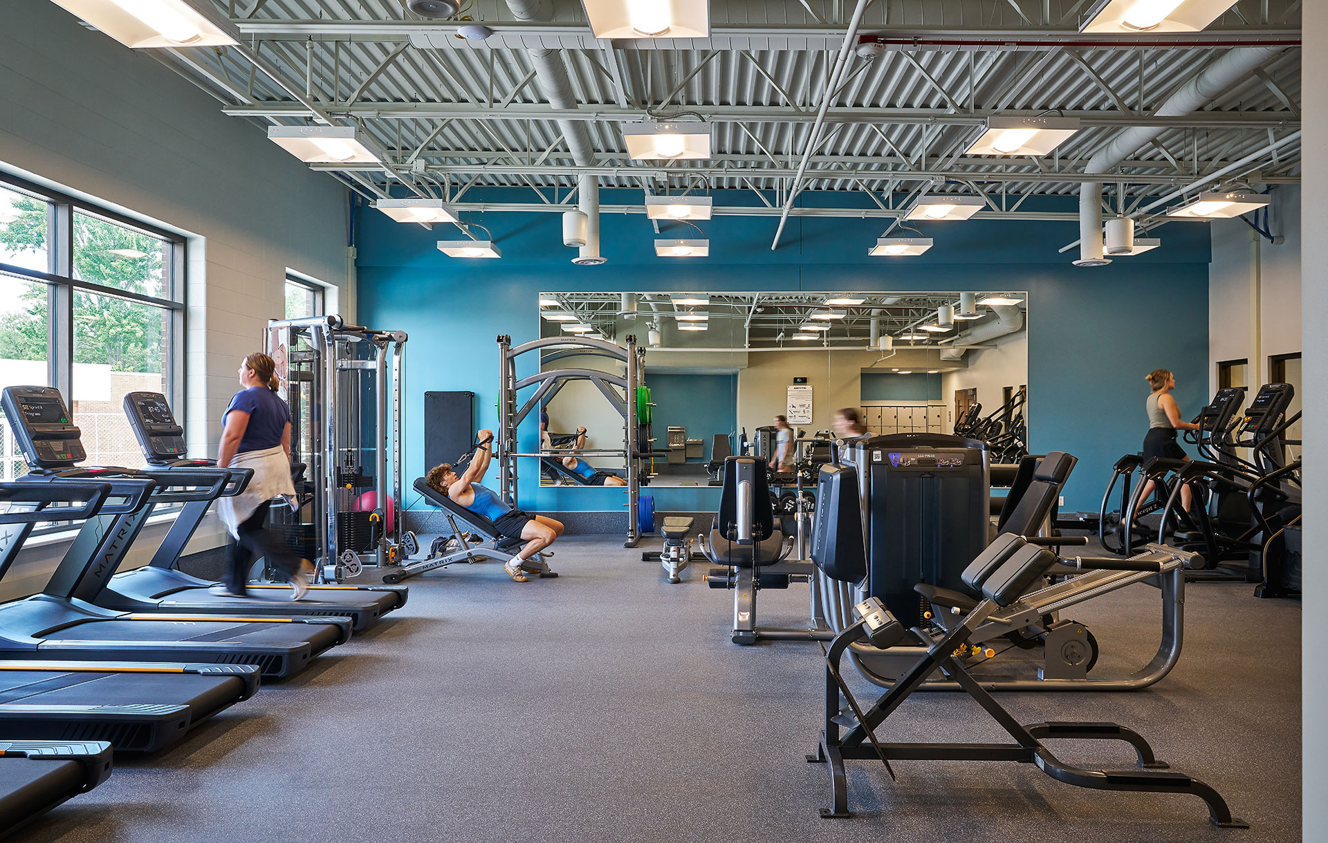 24 hour fitness area with framed mirror and gym equipment